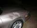 1997 Lincoln Mark VIII - The front passenger side of a car shows significant damage to the fender and hood area.