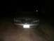 1997 Lincoln Mark VIII - The front end of a Lincoln Mark VIII is illuminated by headlights at night, showing its grille and license plate.