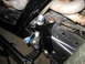 1996 Ford Bronco - Detail of a vehicle's suspension system, focusing on a newly installed bracket and hardware.