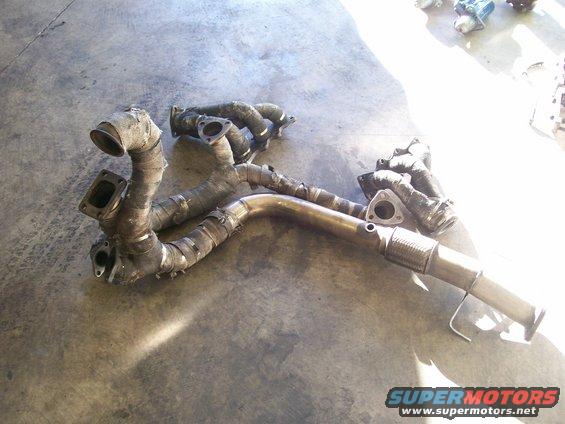 Exhaust manifold with heat wrap and flex pipe on concrete floor