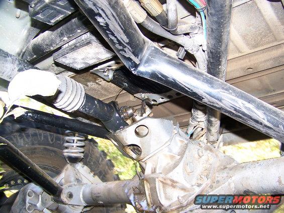 Underside view of a vehicle's drivetrain components, including a driveshaft and differential