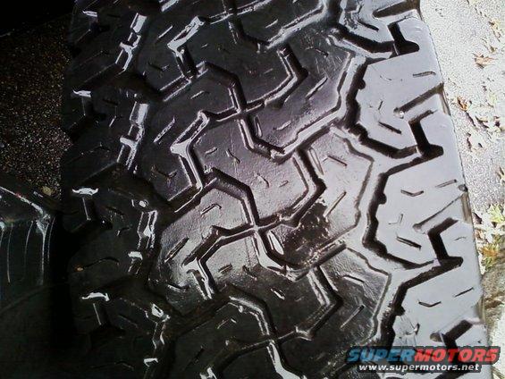 Close-up of a black off-road tire tread with deep, angular blocks