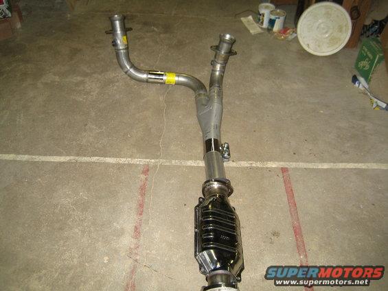 Exhaust Y-pipe and catalytic converter assembly on concrete floor