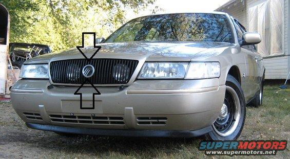 2000 Mercury Grand Marquis front grille with arrows pointing to badge and license plate area