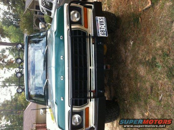 Green 1978 Ford Bronco front view with a black grille guard and a license plate