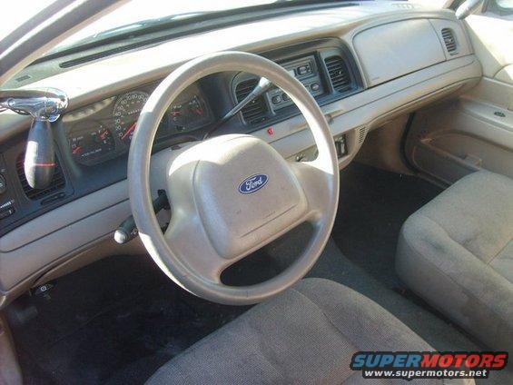 Interior view of a 2004 Ford Crown Victoria showing the dashboard, steering wheel, and seats