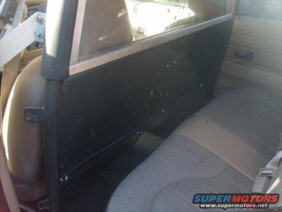 Interior shot of a partition separating front and rear seats in a vehicle