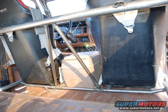 Interior view of a 1982 Ford Bronco with roll cage and bucket seats