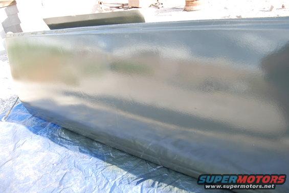 Green painted panel on blue tarp