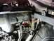 2002 BMW 3 Series - A close-up view of various engine components, including hoses and wiring, with a red arrow indicating a specific wire harness.
