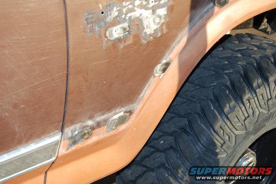 Brown Ford Bronco fender with rust repair and large off-road tire