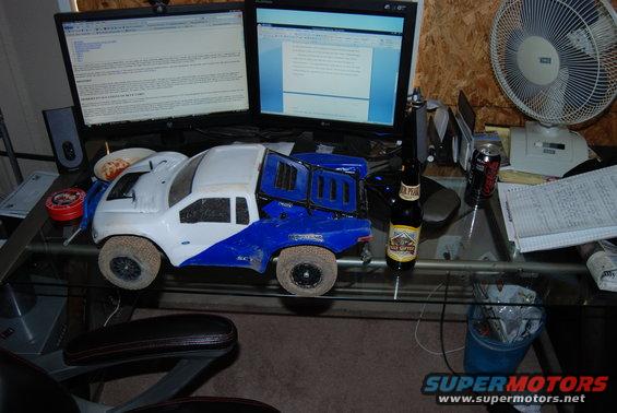 White and blue remote control truck on desk