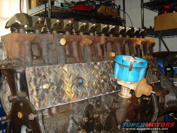 Engine block with blue distributor cap and diamond plate cover