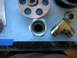 1996 Ford Bronco - Various metal fittings and O-rings are displayed on a blue textured surface.