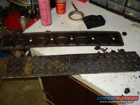 Engine valve cover with diamond plate and various tools on a workbench