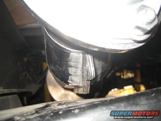 Close-up of a chrome exhaust pipe tip with visible scratches