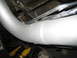 1996 Ford Bronco - Close-up view of vehicle undercarriage components including exhaust and suspension.