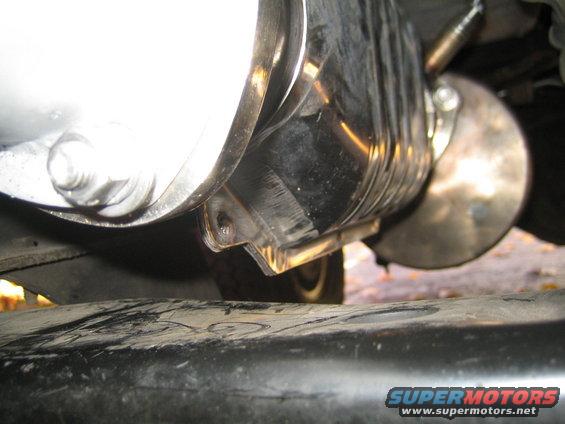 close-up of vehicle exhaust system, showing muffler and pipe