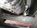 1996 Ford Bronco - Close-up view of a chrome exhaust pipe with a clamp and black hose attached.