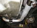 1996 Ford Bronco - Underside view of vehicle exhaust pipe and transmission pan, showing 'Metric' casting.