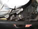 1996 Ford Bronco - Underside view of a vehicle's exhaust system, showing a chrome-plated component and associated piping.