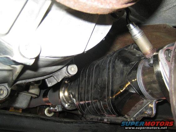 Exhaust catalytic converter with shiny metal casing and an oxygen sensor attached