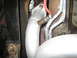 1996 Ford Bronco - Close-up view of a vehicle's exhaust system, showing an oxygen sensor and piping.
