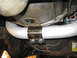 1996 Ford Bronco - Close-up view of an exhaust pipe section with a clamp, likely part of a vehicle's undercarriage.