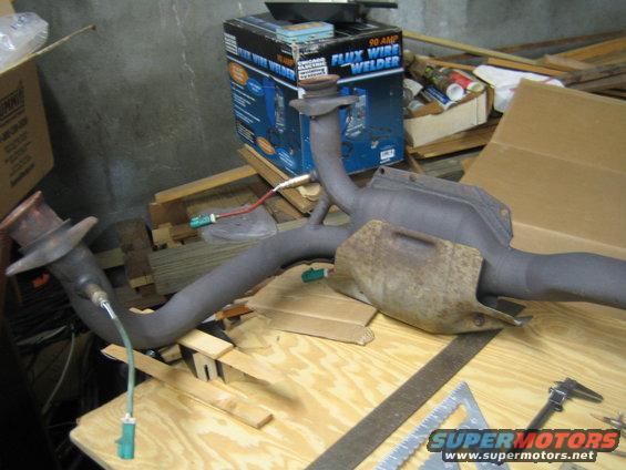 exhaust pipe with sensors on a workbench next to a welder box