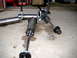 1996 Ford Bronco - Three hydraulic shock absorbers with hoses are laid out on a concrete floor.