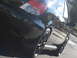 2005 Subaru Impreza - The rear of a black 2005 Subaru Impreza is shown from a low angle, highlighting the taillight and wheel.