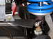 1996 Ford Bronco - Custom suspension part with a blue spring and black strap is bolted to a vehicle's frame.