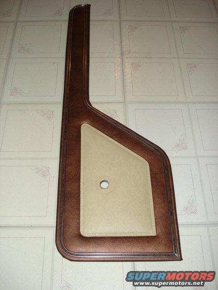 Brown and tan door panel with a hole in the center