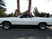 1973 Ford Ranchero - Side profile of a 1973 Ford Ranchero, a white exterior with black accents and a black vinyl roof.