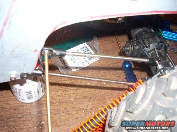 RC car suspension linkage and shock absorber components with a parts bag