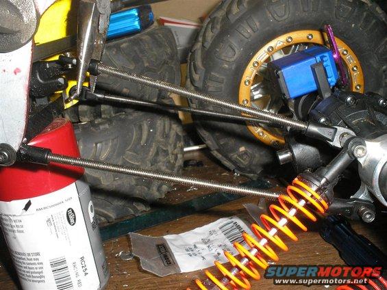 RC car suspension with orange coilover shock and blue servo