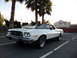 1973 Ford Ranchero - A white 1972 Ford Ranchero is parked in a lot with palm trees in the background.