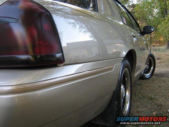 Gold Mercury Grand Marquis, rear quarter panel, tinted taillight, chrome trim, chrome wheel