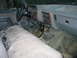 1984 Ford Bronco - Interior of a truck with a manual transmission and worn fabric seats.