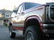 1984 Ford Bronco - This Ford Bronco features a two-tone paint scheme with chrome accents and off-road tires.