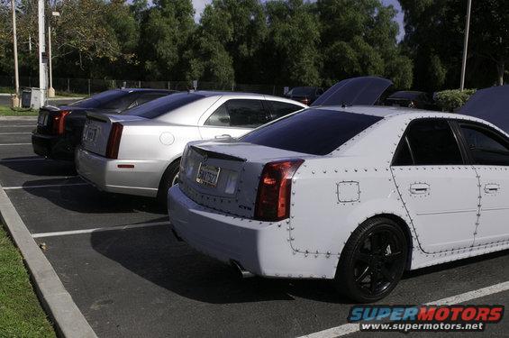 White 2006 Cadillac STS with riveted body panels parked in a lot