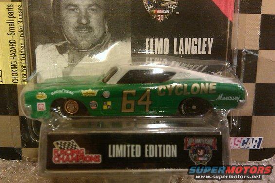 Green and white toy race car with number 64 and CYCLONE text, in packaging