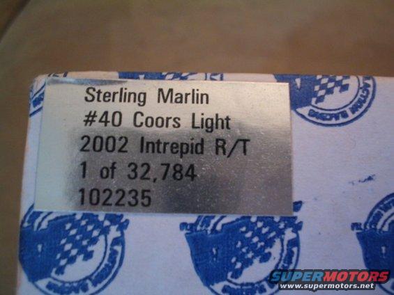 Metal plate with text: Sterling Marlin #40 Coors Light 2002 Intrepid R/T 1 of 32,784 102235. Blue checkered pattern on white box
