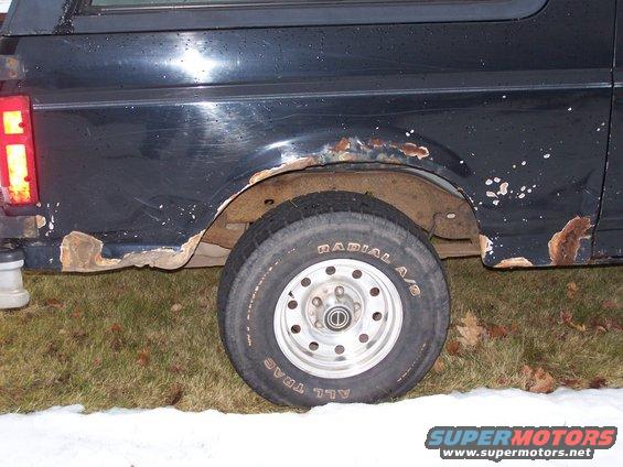 Black 1996 Ford Bronco side view showing rust damage