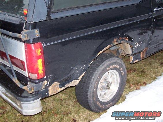 1996 Ford Bronco rear quarter panel showing rust damage and a taillight