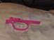1990 Max II - A bright pink trigger assembly is shown resting on a patterned fabric surface.