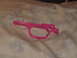 1990 Max II - A pink gun frame lies on a patterned fabric surface, showing its intricate design and construction.