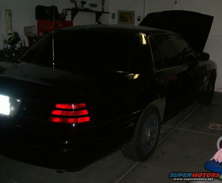 Black 2002 Ford Crown Victoria, rear quarter view with hood open