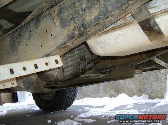Undercarriage view of a 1986 Ford F-150 showing the fuel tank, transmission, and frame rails