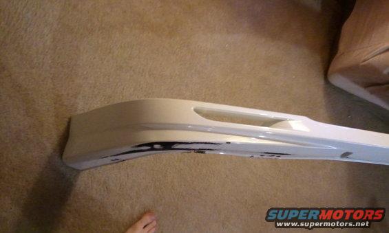 White car bumper part with black markings